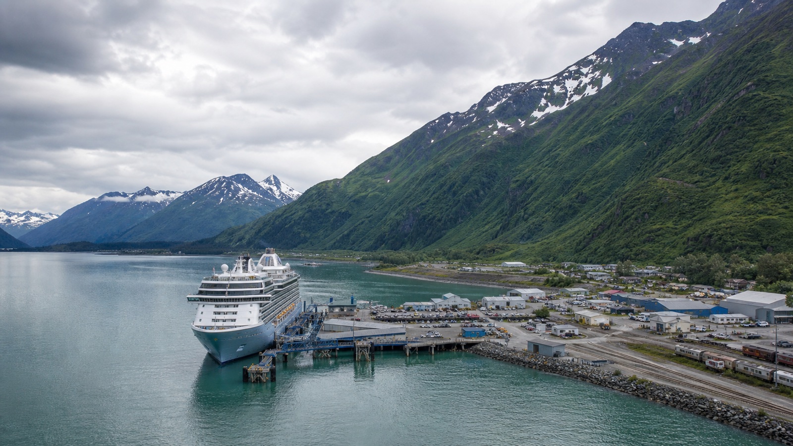 Seward cruise terminal beside Resurrection Bay, railway tracks and steep green mountains