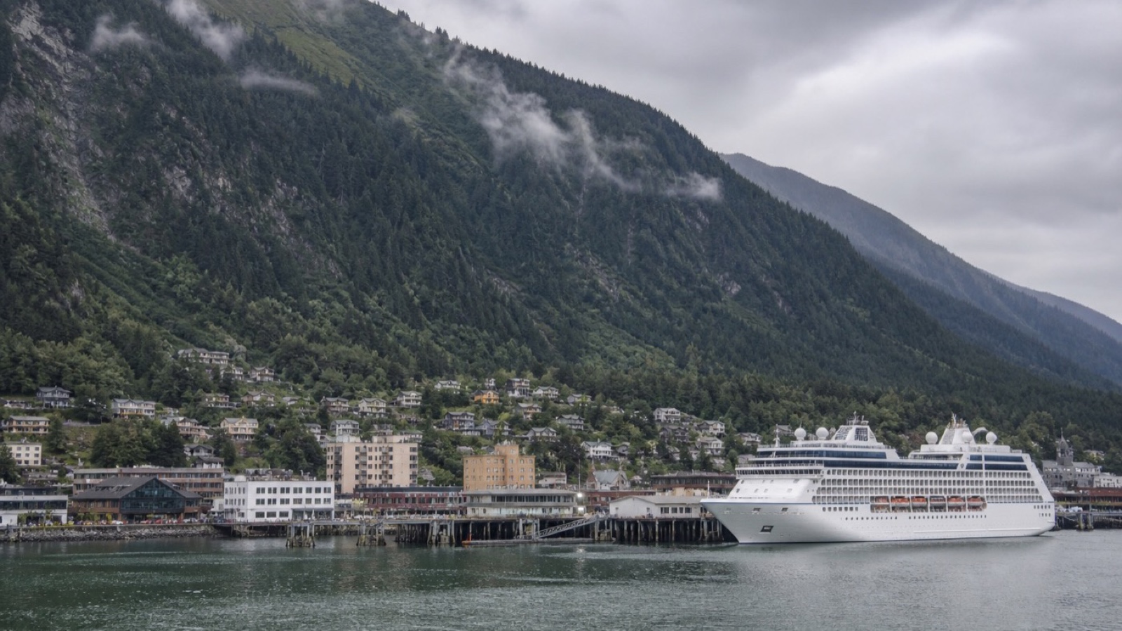 Juneau waterfront and forested mountains seen from the harbor