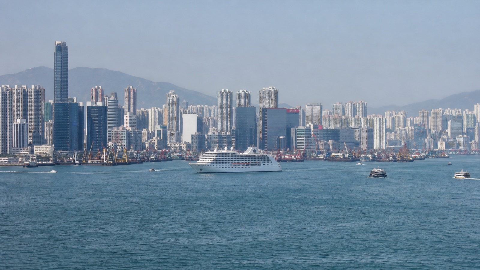 Unbranded cruise ship approaching a large Asian harbor with a realistically scaled city waterfront