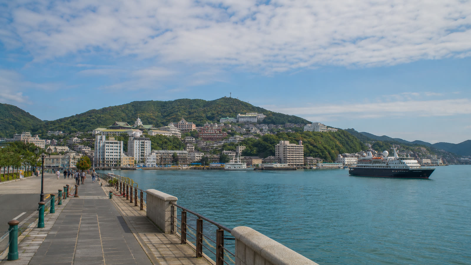 Travelers beginning an Asian shore excursion from a busy waterfront