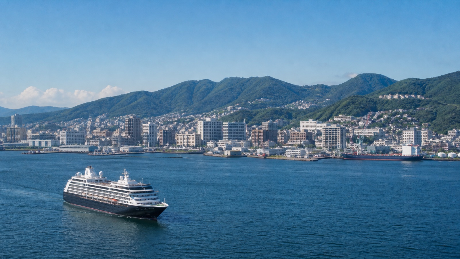Unbranded cruise ship on a Korea and Japan route with a coastal city beyond