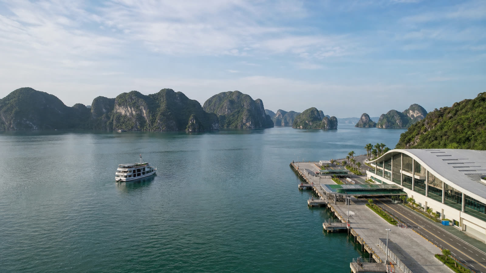 Ha Long passenger terminal, local touring vessel and limestone karsts at natural scale