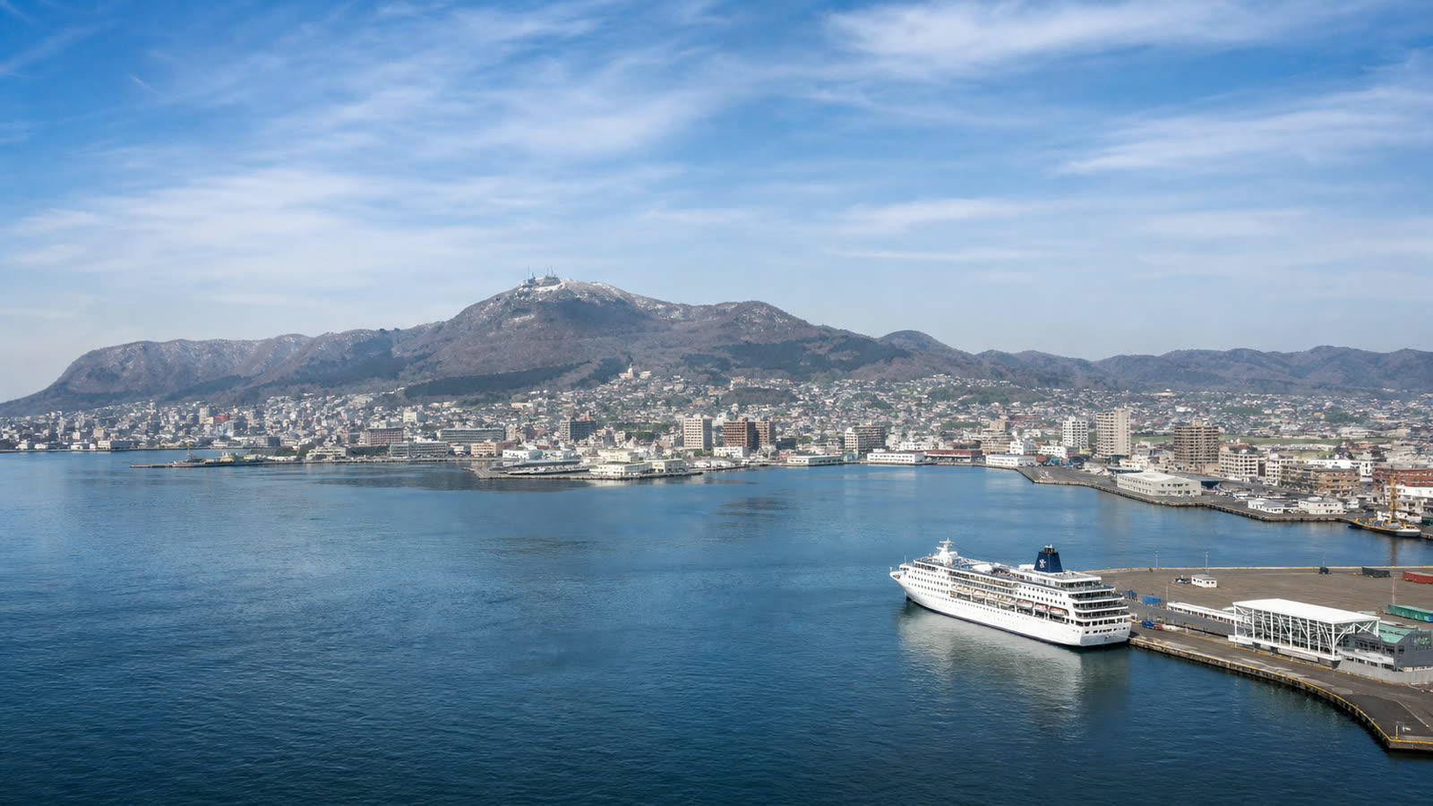 Hakodate cruise harbor and coastal city with an unbranded ship beneath northern light