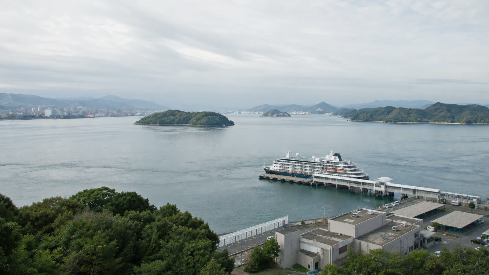 Hiroshima cruise pier and sheltered inland-sea landscape with an unbranded ship