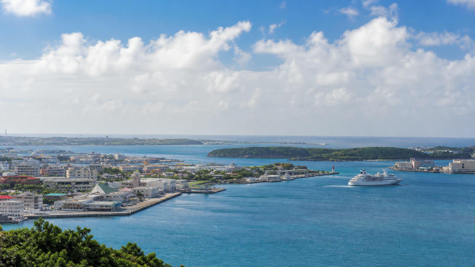Naha cruise harbor, turquoise water and Okinawa city waterfront with an unbranded ship