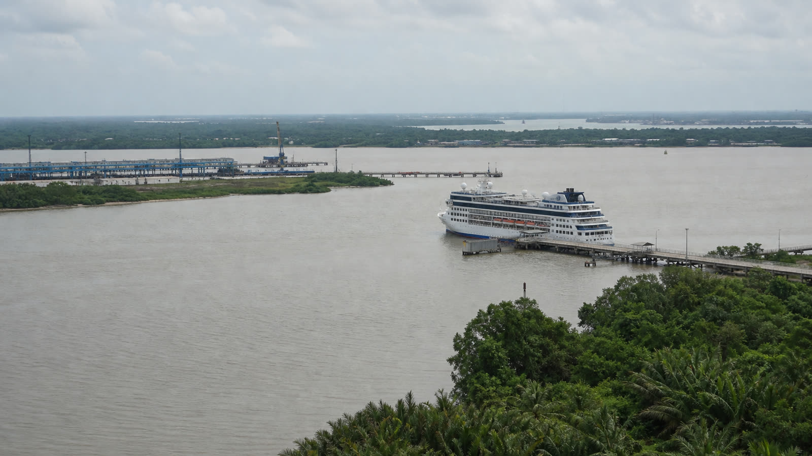 Phu My working cruise berth with an unbranded ship and low industrial waterfront