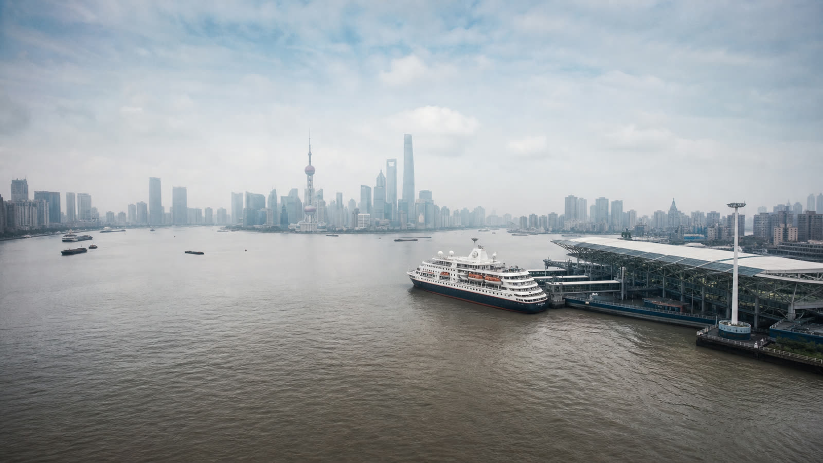 Shanghai cruise harbor with an unbranded ship and the distant skyline at realistic scale