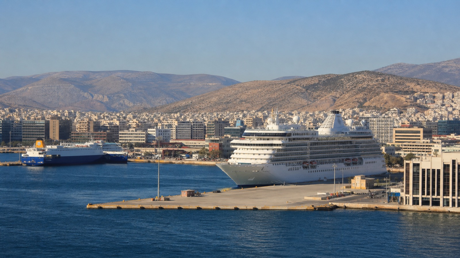 Piraeus cruise harbor with an unbranded ship, working port and Attica hills