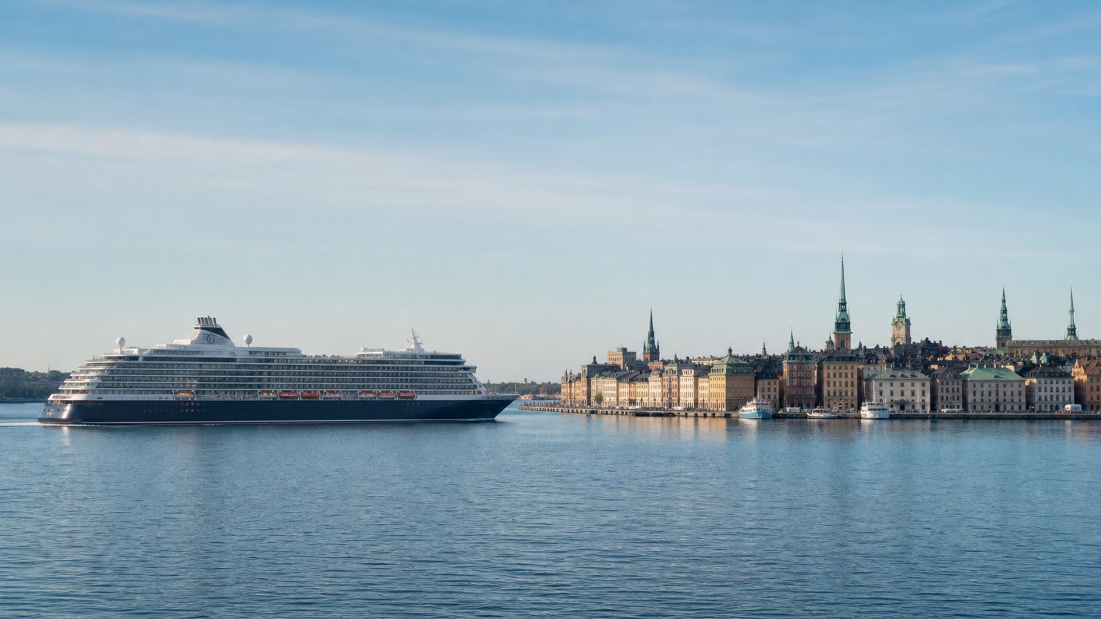 Unbranded cruise ship approaching a Baltic capital across calm water