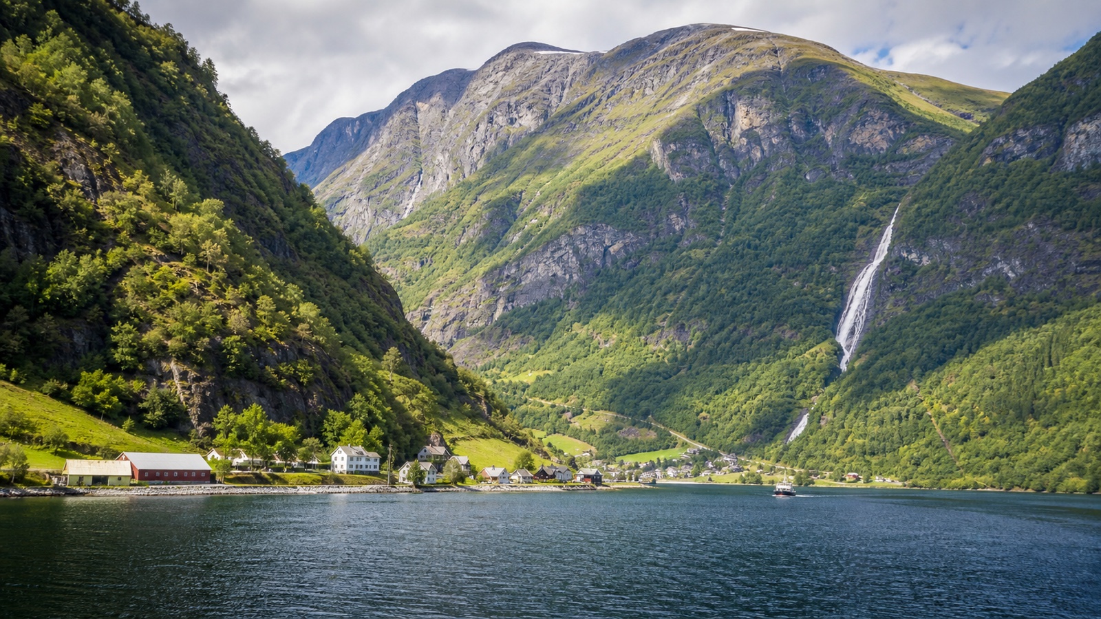 Flåm cruise port beneath steep green fjord mountains