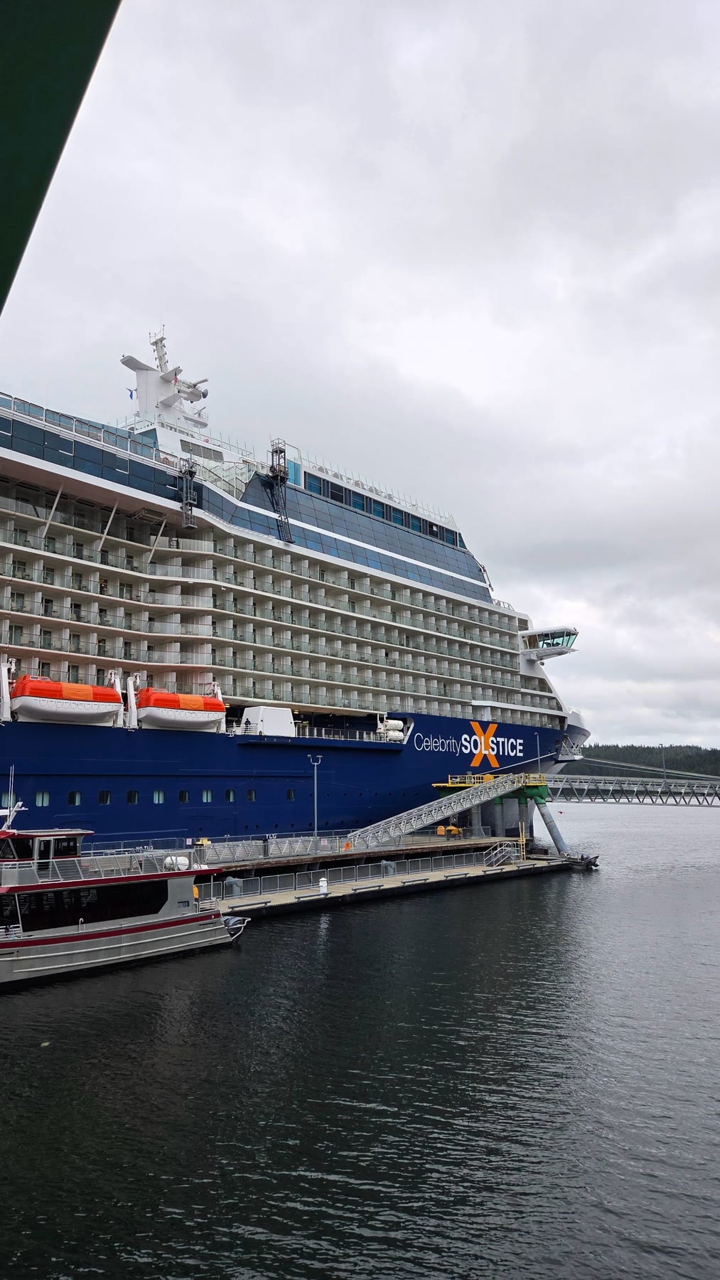 Celebrity Solstice docked at Skagway beneath a cloudy sky